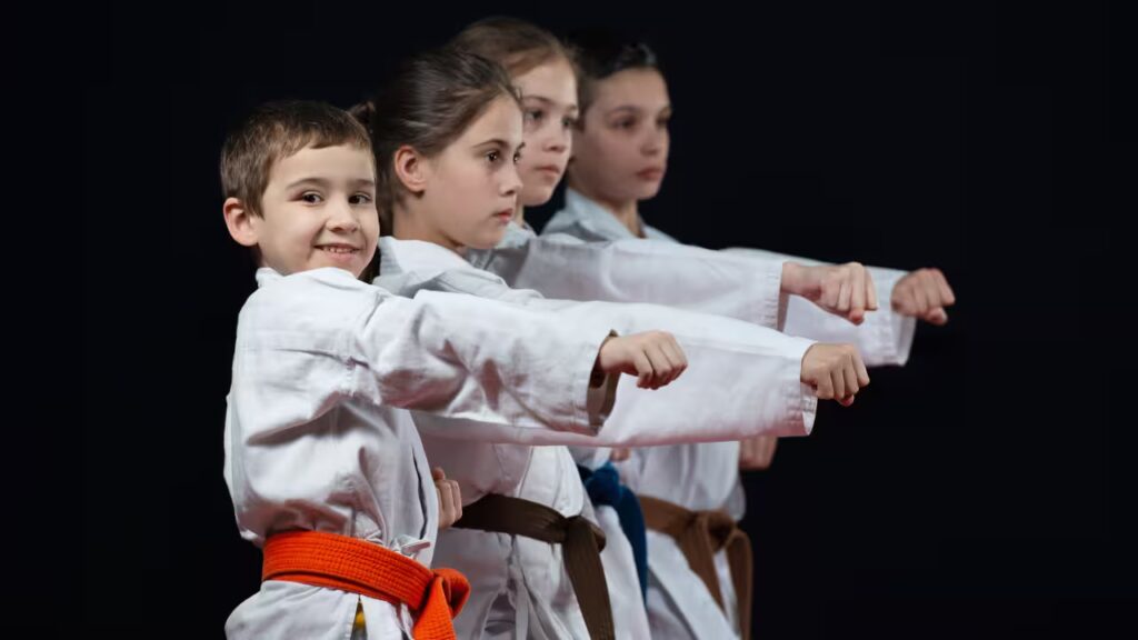 Martial arts class for kids in a modern gym, children practicing different martial arts techniques under the supervision of an instructor.