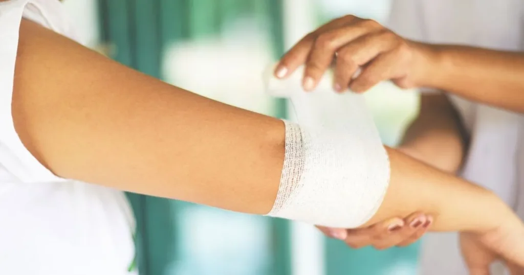 Wrapping an injury on a childs arm using first aid tips for kids