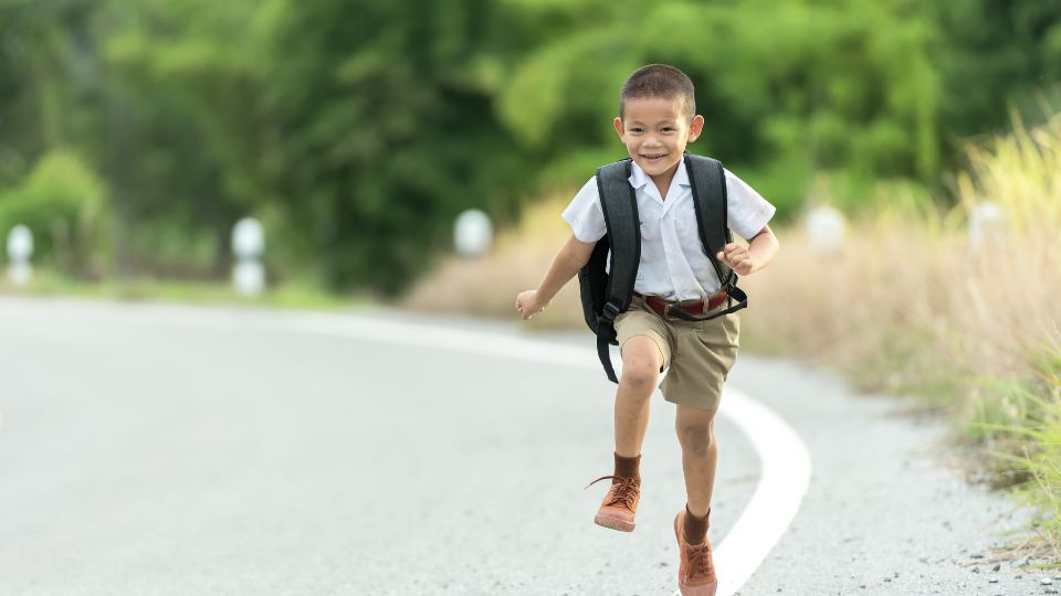 A boy skipping down the road