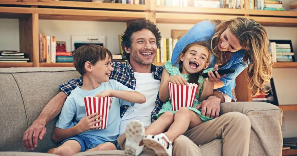 A family eating popcorn enjoying family fun night